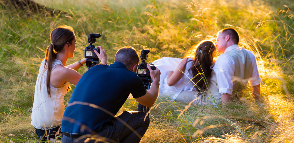 Bride and groom pose for wedding photographers