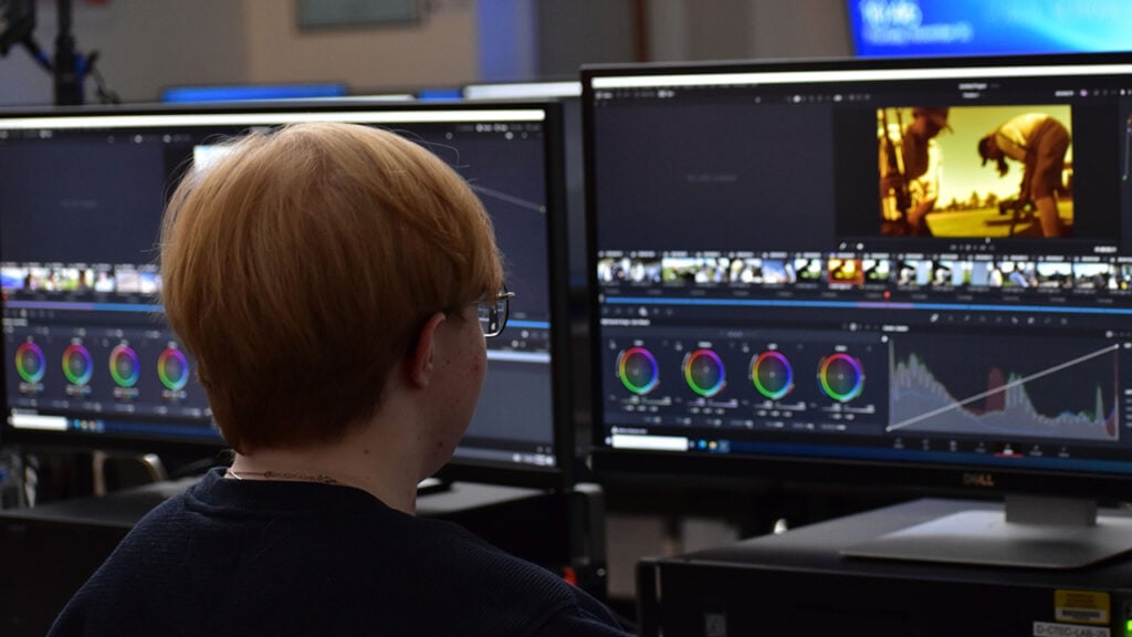 high school student operates DaVinci Resolve on a computer