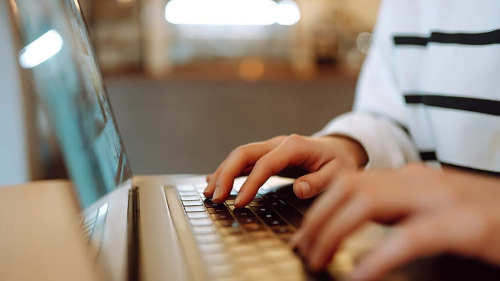 Melanie Ciotti types on a computer
