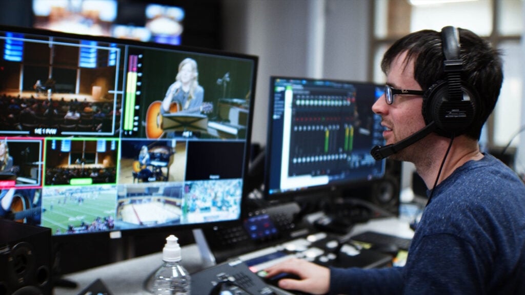 A man edits video in DaVinci Resolve on a computer