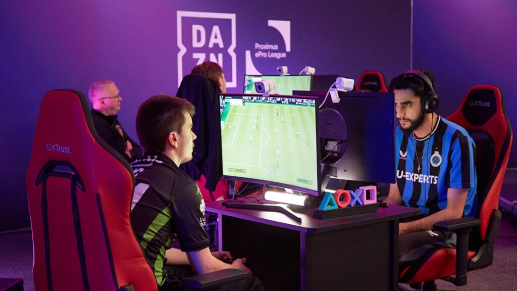 Men sit before screens playing sports video games