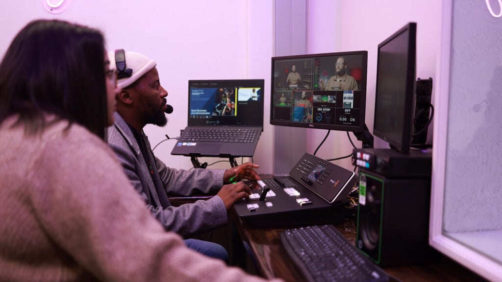two people edit using Blackmagic DaVinci Resolve in a studio