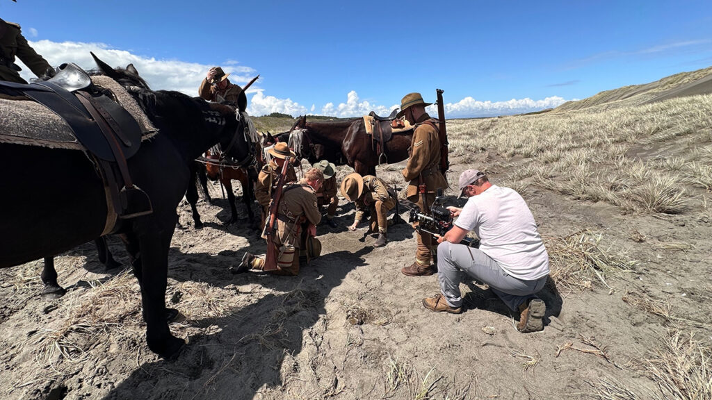 A man uses a Blackmagic Camera to film a scene in the documentary Devils on Horses