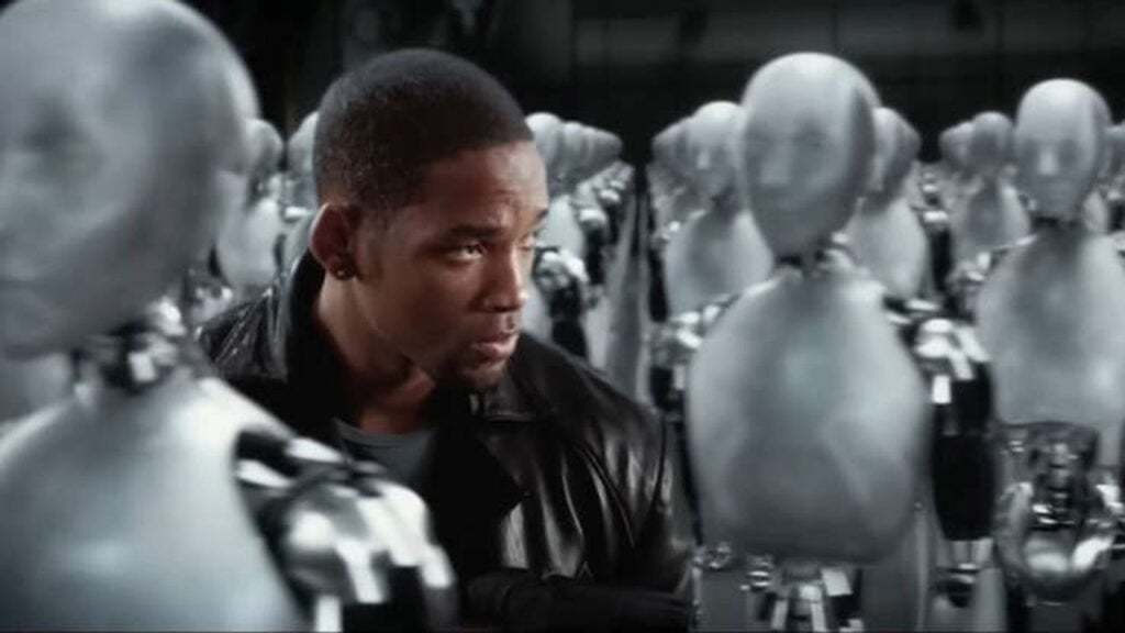 Will Smith walks among white robots in a scene from the movie I, Robot
