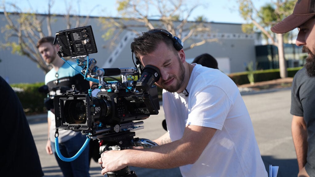 A man looks into the viewfinder of a Blackmagic URSA Cine 12K camera
