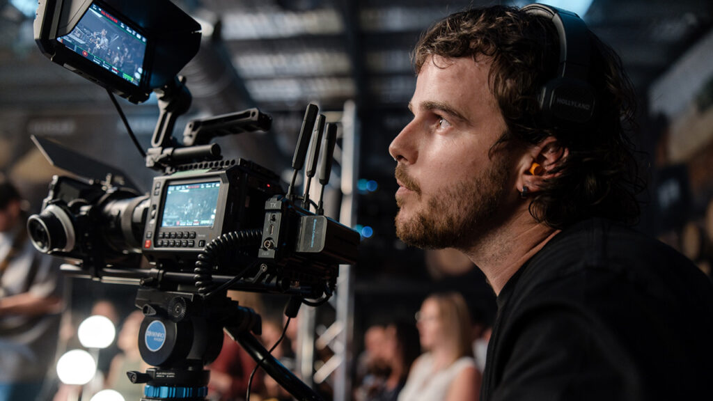 A man looks at the display of his Blackmagic Camera