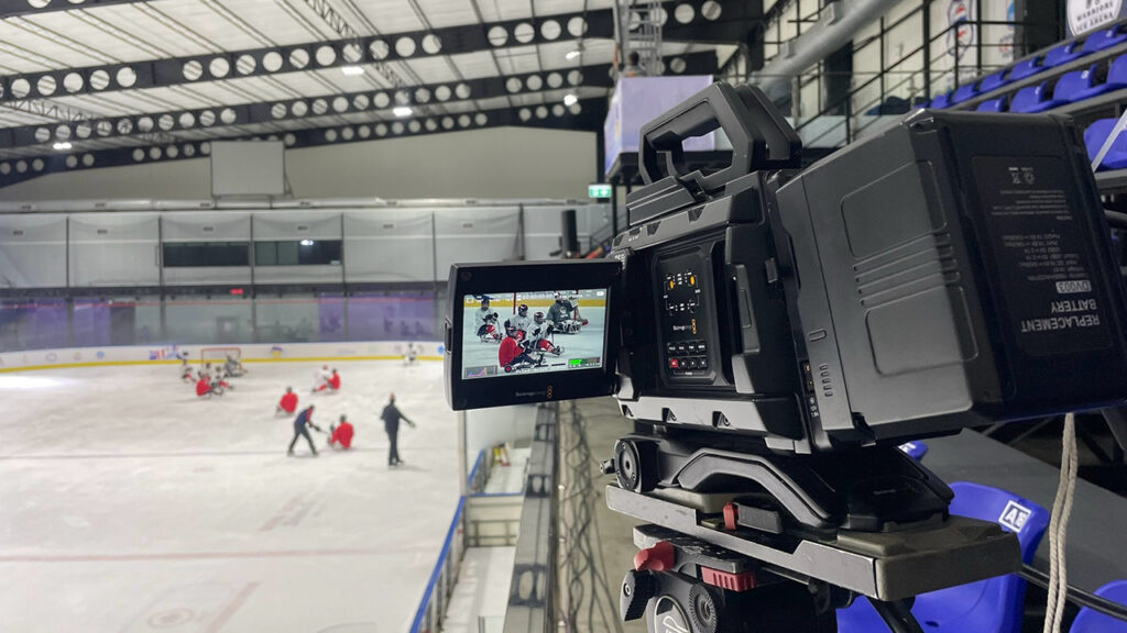 A camera films a game of hockey