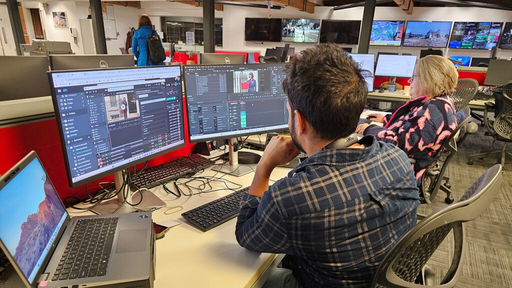 a man working at AP uses DaVinci Resolve software on a computer