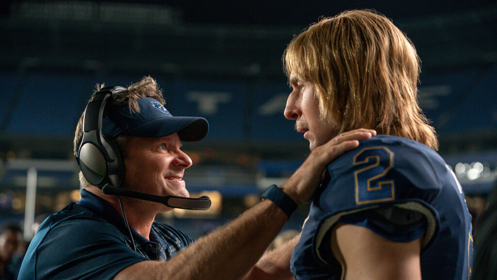 A coach encourages a football player