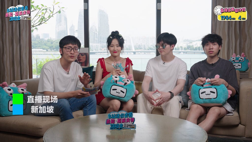 a girl and three guys sit on a couch while live streaming from Singapore