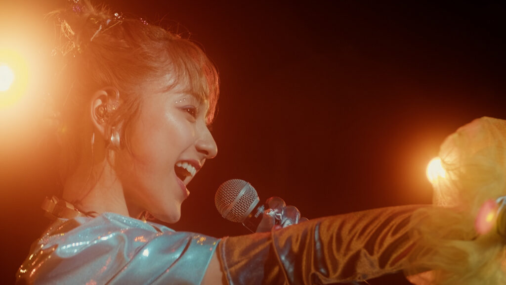 A woman sings into a microphone
