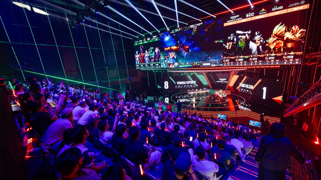 a crowd cheers in an eSports stadium