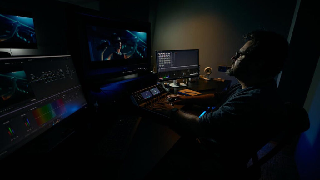 A man carries out post-production using DaVinci Resolve Studio software in a studio
