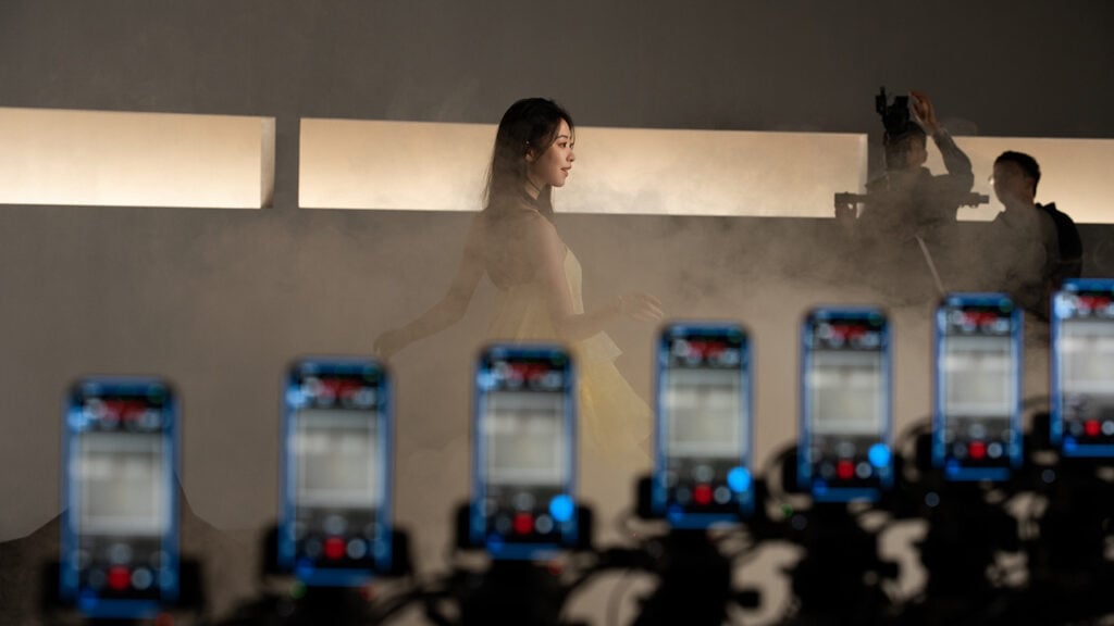 a woman dances behind a series of iPhone cameras