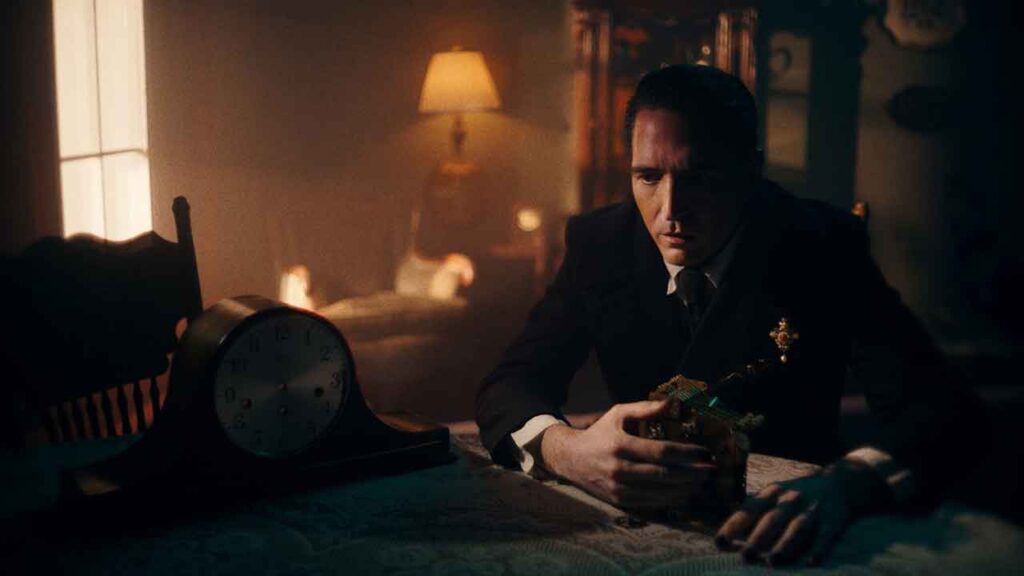 A man sits in a low-lit room in a scene from the film Metanoia