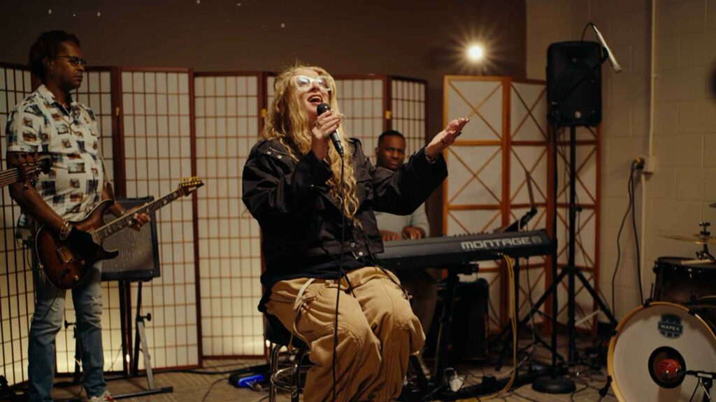 A woman sings at the Restoration Christian Fellowship