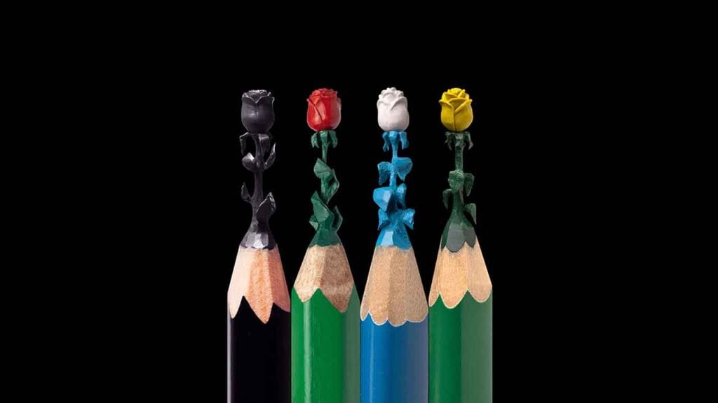 four colored pencils with roses attached to the tips
