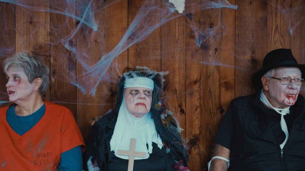 three people sit next to each other in various costumes
