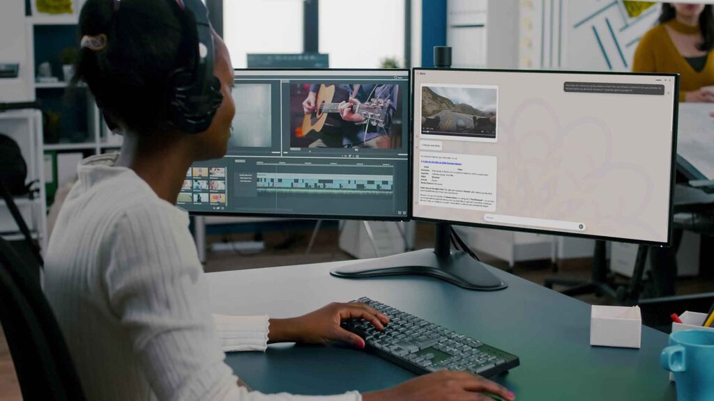 A woman looks at two computer screens that display Dalet software