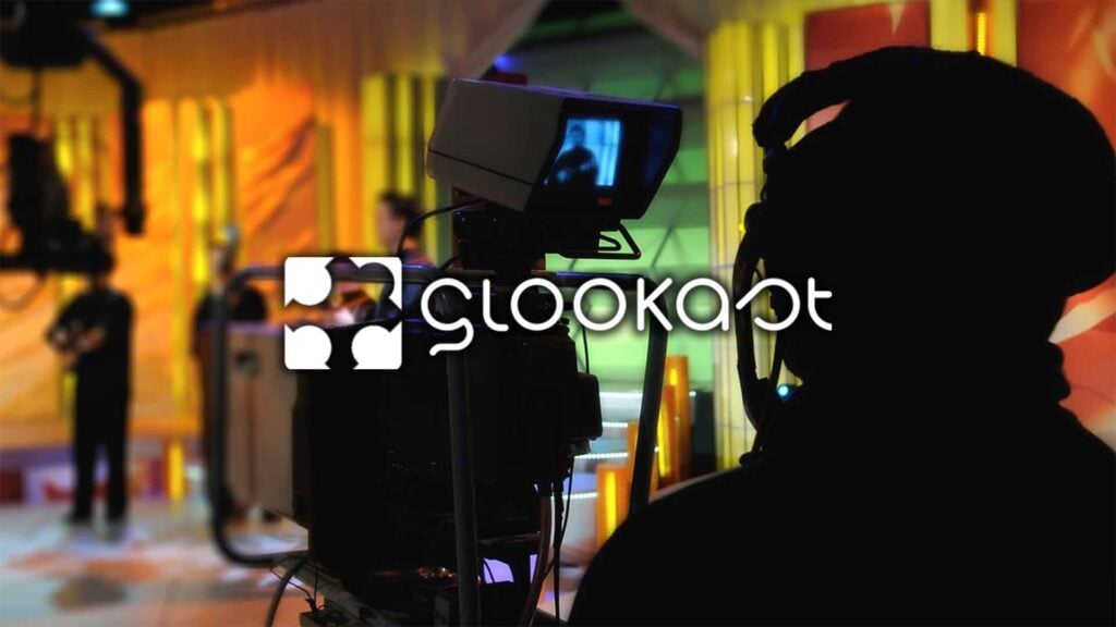 a man runs a camera focused on a set of musicians