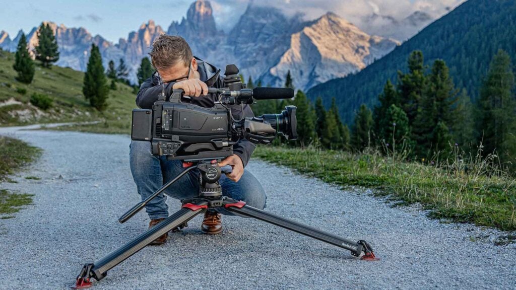 a man secures his camera to an active camera support