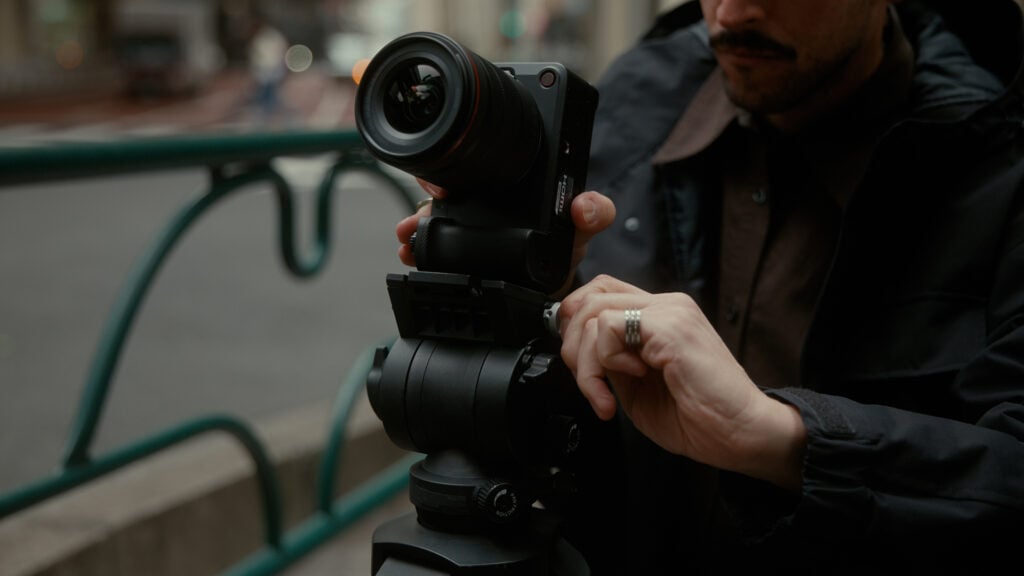 A man adjust his Canon EOS R6V Camera