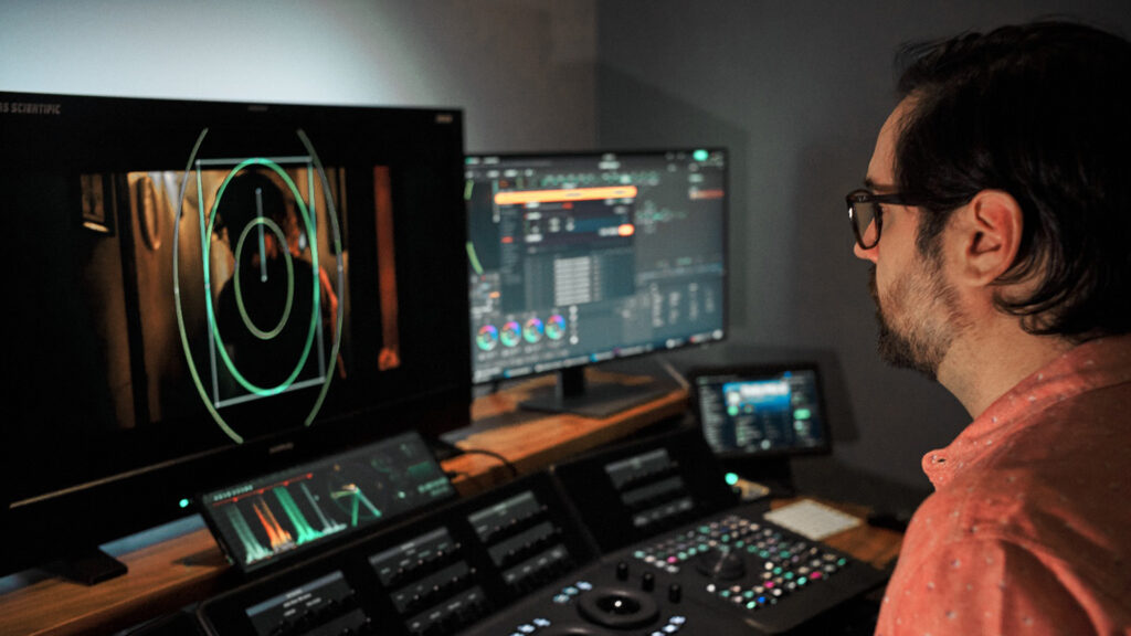 A man stares at his monitor while editing video footage