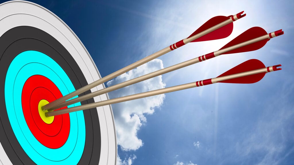 several arrows are stuck in the bullseye of a target
