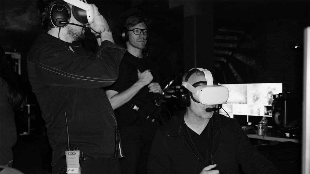 Three men use VR headsets