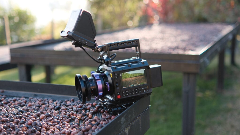 A PYXIS camera rests next to coffee beans