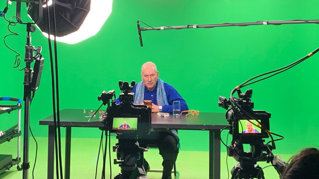 a man sits on a Mirai Media set during Digital and Broadcast Production with Blackmagic Design gear