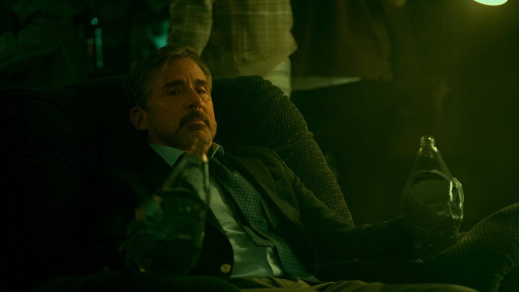 Steve Carell sits in an armchair in a scene from Rooster