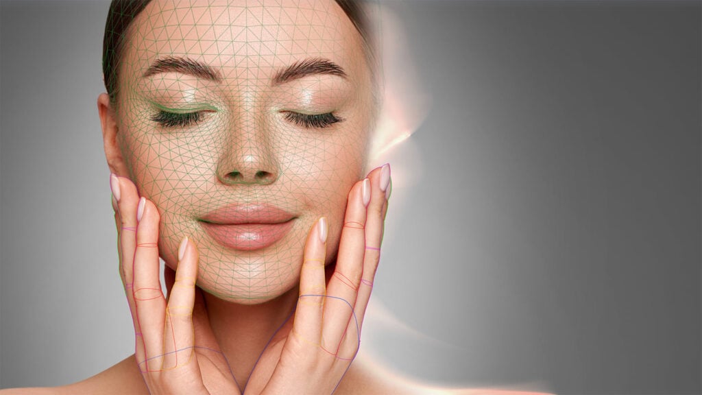 a woman poses with eyes closed and hands to her face