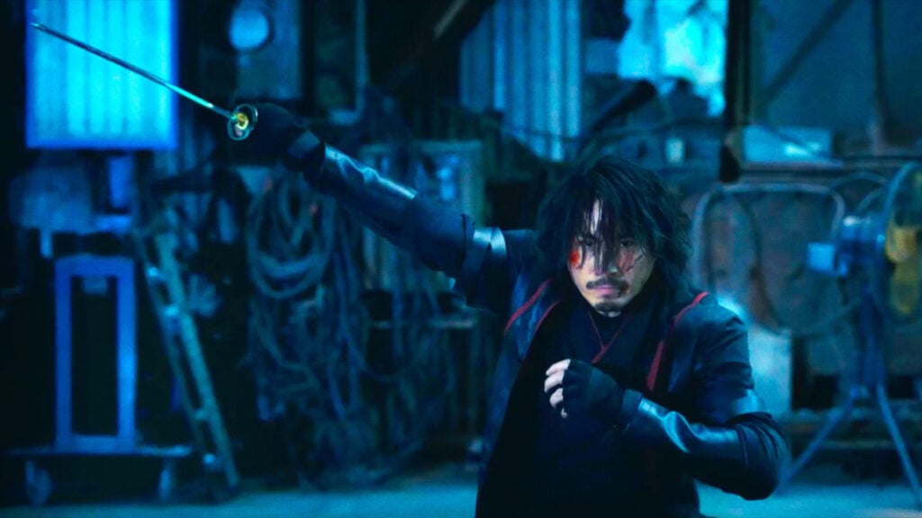 a scene from the film SEEK showing a man holding a sword