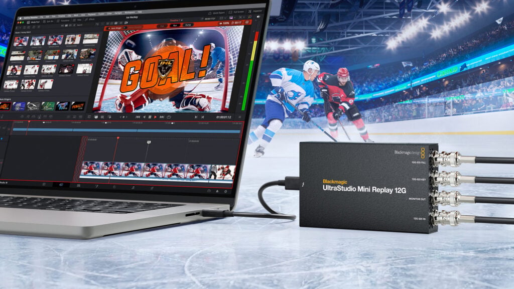 a computer and a Blackmagic UltraStudio Mini 12G device rest on the ice of a hockey rink