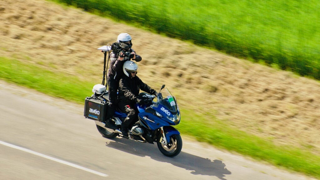 a motorcyclist with a camera films the Paris-Troyes en Champagne bike race with AVEO