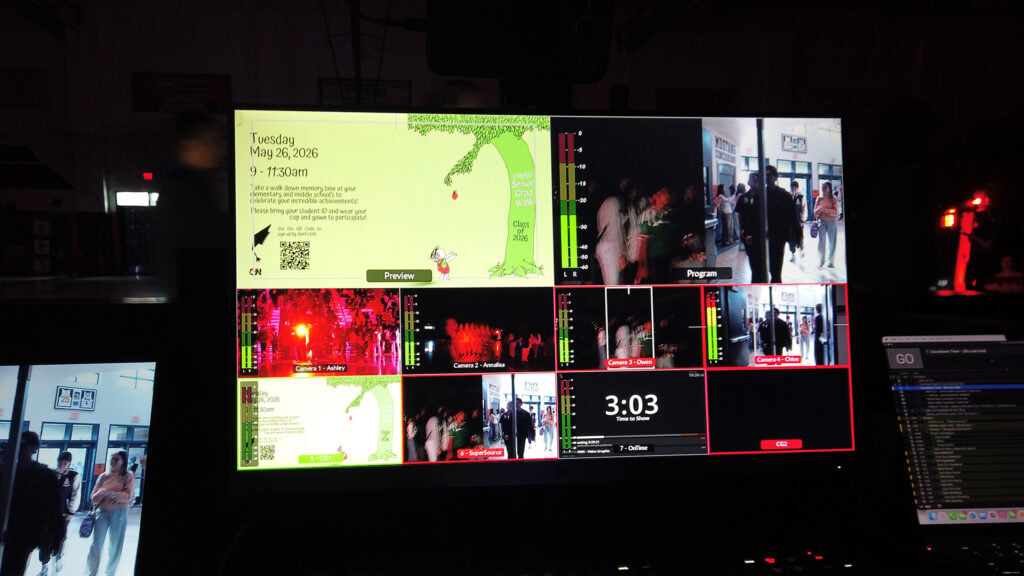 a monitor that switches between several cameras at an Eleanor Roosevelt High School rally