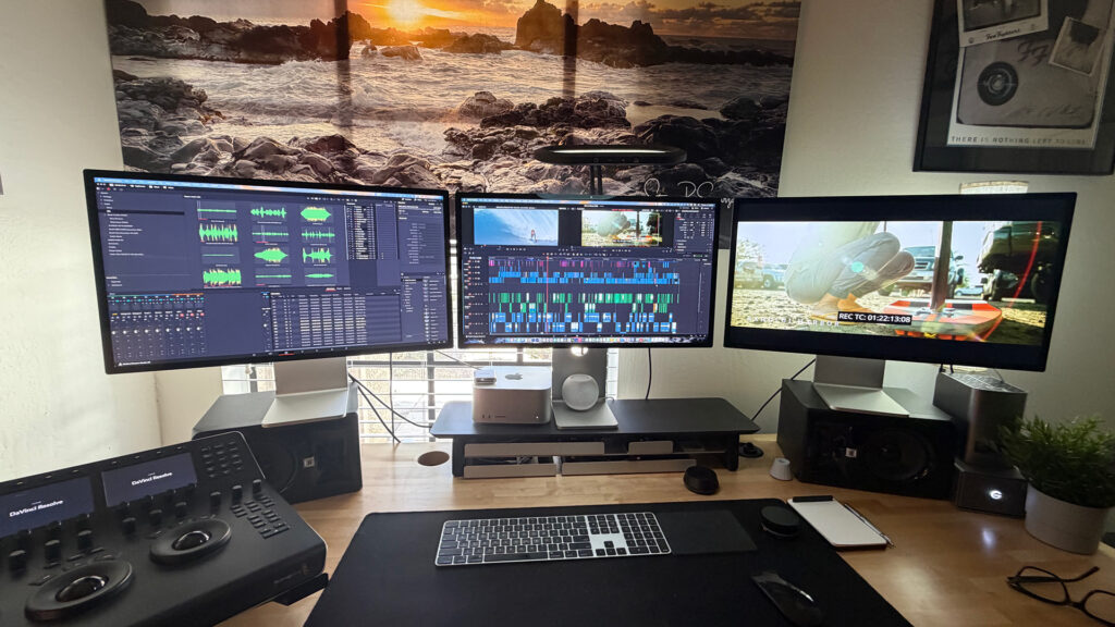 three screens on a desktop display DaVinci Resolve Studio software as an editor edits footage of the documentary Life on Waves