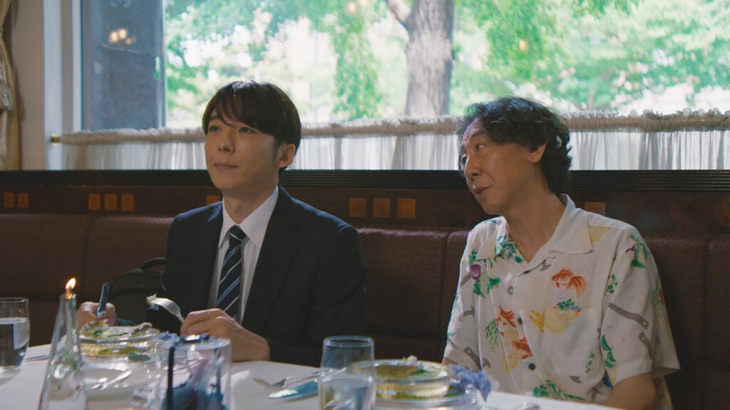two people sit at a table in a restaurant