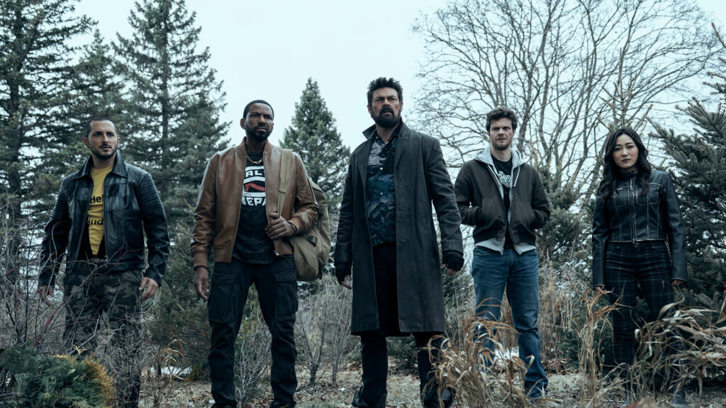 five people wearing jackets stand in a forest setting in a screenshot from the show The Boys