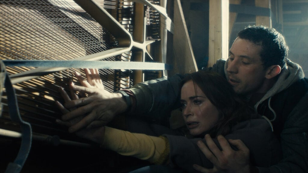 a scene from the film Disclosure Day featuring a man holding a woman back