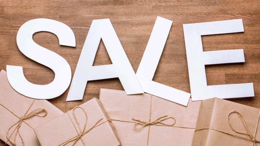 the word Sale in white above brown packages