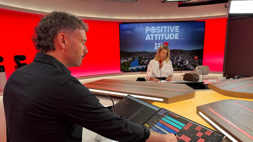 A man pushes a button in a news broadcast studio