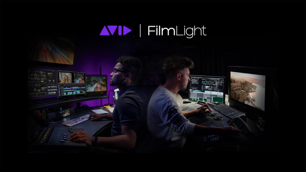 two men sit at desks editing video footage